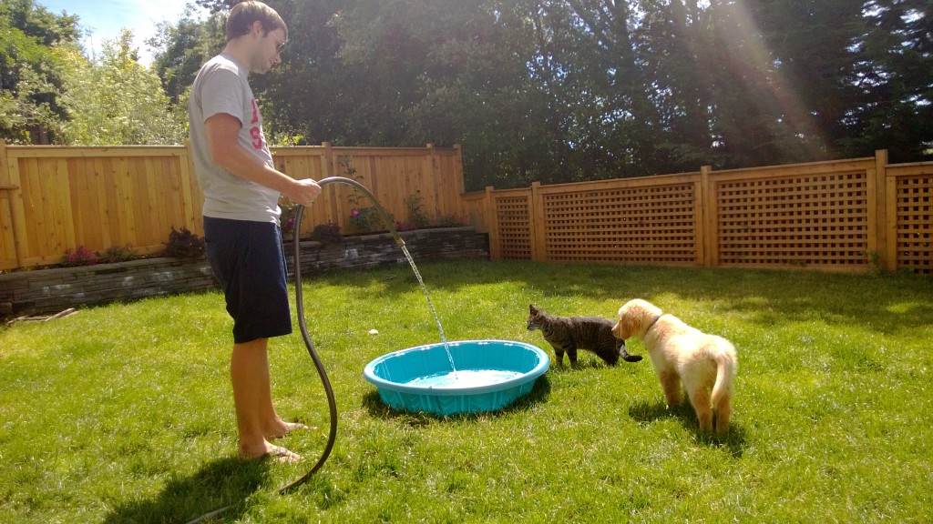 Alex filling up the pool for Henry and Jackson.