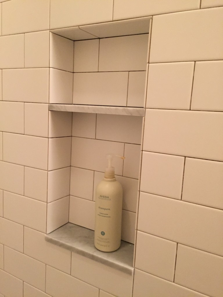 {The storage niche will be perfectly handy for holding our shampoos and soaps.}