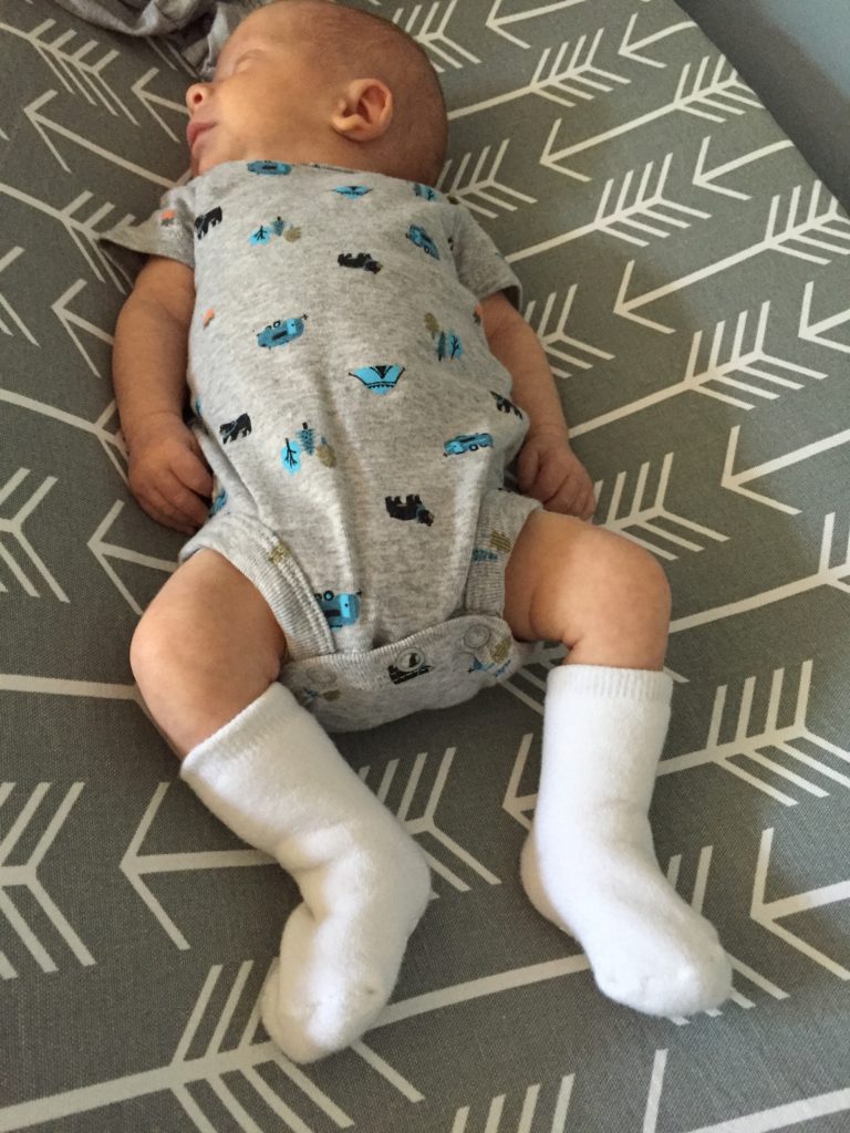 {I think he looks like an old man here with these gigantic, tall socks! These socks are size 0-3 months and the feet part fit him, but the legs make them like knee-highs!}